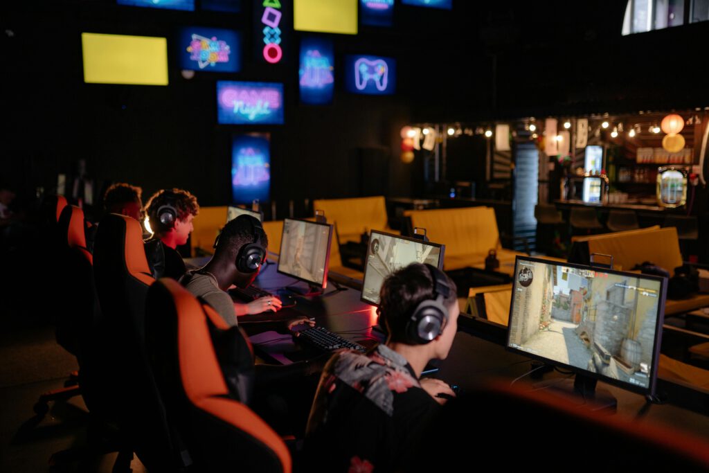 pexels photo 9072248 9072248 Group of gamers participating in an online tournament at a modern internet cafe.