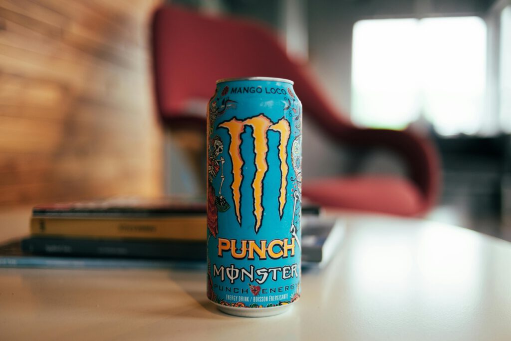 pexels photo 9170100 9170100 Close-up of Monster Punch energy drink can on a table in a cozy indoor setting.